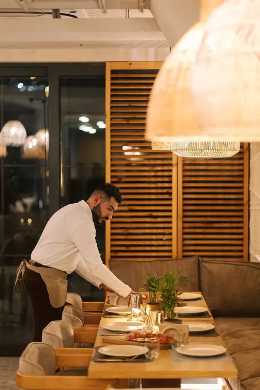 Waiter laying a table