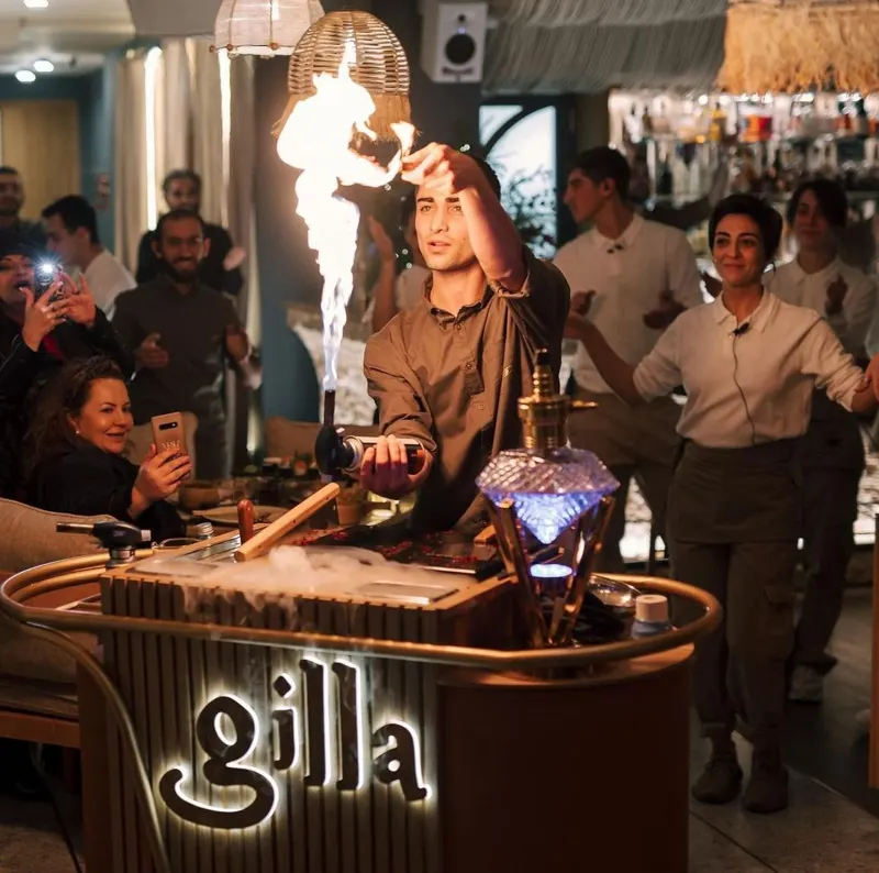 Hookah master performing the fire show in the lounge