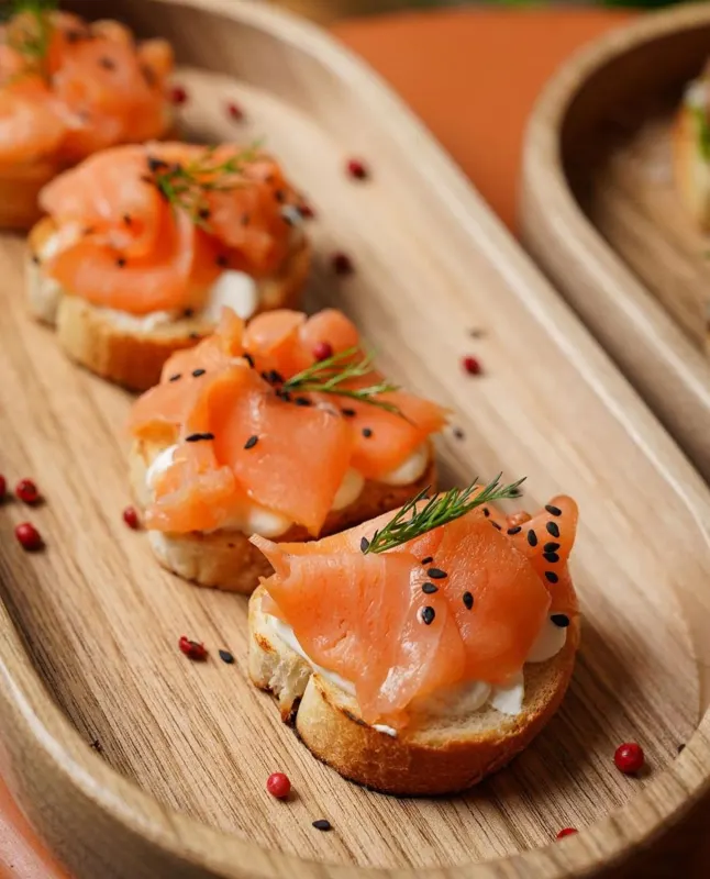 Salmon crostini on a wooden board